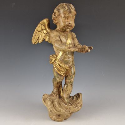 une image représentant une statue d'ange ailé posé sur un rocher