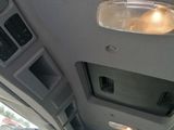 the interior of a vehicle with the door open and the lights on