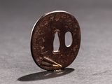 a small piece of metal with a face on it