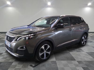 a grey car is parked on a checkered floor in a showroom