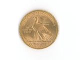 a gold coin with a bird on it on a white surface