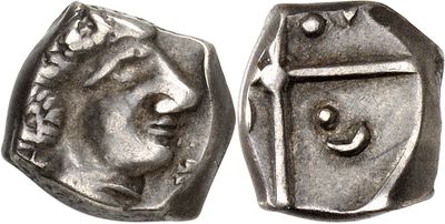 a close up of a coin with a face on it