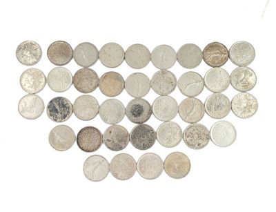 many different types of coins arranged together on a white surface