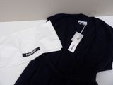 a black and white shirt and a white shirt on a table