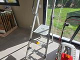 a ladder that is next to a window in a room
