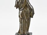 an image of a bronze statue of a woman holding a child