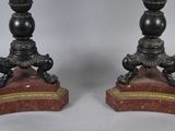 pair of black and gold candlesticks on marble bases