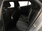 the back seats of a car with the door open and the driver ' s seat down