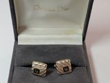 pair of silver cufflinks with black and white stripes in a gift box