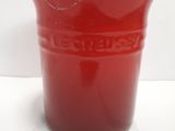 a red cup that is sitting on a white surface
