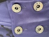a close up of a purple jacket with buttons on it