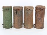 three old tin cans are sitting next to each other on a white surface