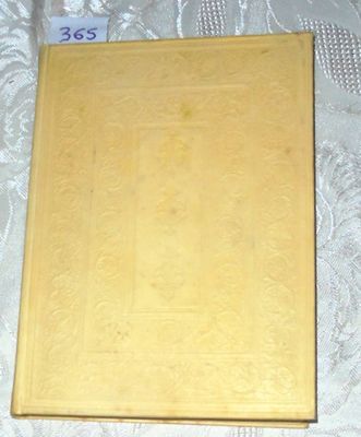 a yellow book on a bed with a white sheet