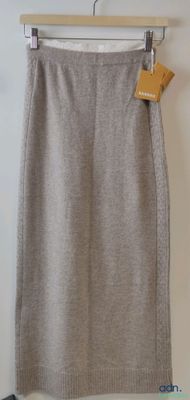 the skirt is made of wool and has a zipper at the waist