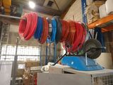 many different colored hoses on a rack in a warehouse