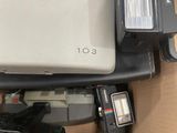 a box with a camera, flash, camera, and other items in it
