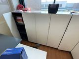 a blue box sitting on top of a white cabinet