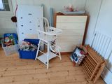 a baby high chair in the corner of a room