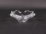 a close up of a clear glass bowl on a black surface