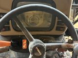 a steering wheel of a tractor that is sitting on the ground