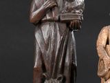 two carved wooden figures of a man and a woman