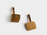 a pair of wooden cufflinks on a white background