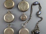 many different types of pocket watches on the table