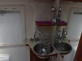 two sinks in the corner of a small bathroom