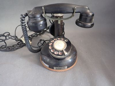 a black telephone that is sitting on a table