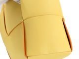 someone in white gloves is holding a yellow bag with a handle