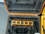 a yellow case with tools inside of it on the floor