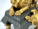 a gold statue of a lion on a black table