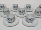 six cups and saucers with blue flowers on them