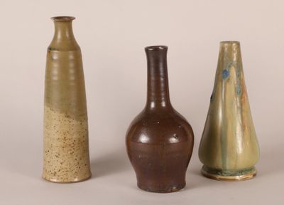 three vases are sitting next to each other on a white surface
