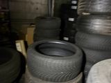 a lot of tires that are stacked up in a room