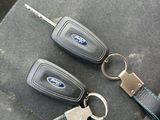 three car keys that are sitting on the seat of a car