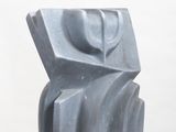 sculpture on a white pedestal in front of a white wall