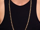 a woman wearing a black tank top and a gold chain necklace