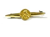 an image of a gold tie bar with a coin on it