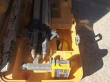 a yellow tool box with tools in it sitting on the ground