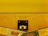 yellow leather handbag with gold hardware and chain strap