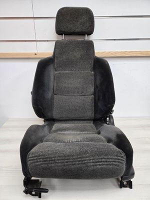 a close up of a car seat on a wooden floor