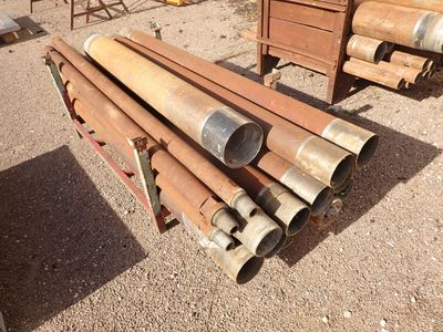 a lot of pipes that are sitting in the dirt