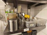 a metal shelf with a bunch of utensils on it