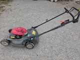 a lawn mower that is sitting on the ground
