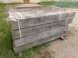 un tas de palettes en bois posées dans l'herbe