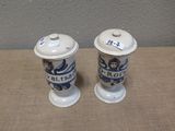 two salt and pepper shakers sitting on a table