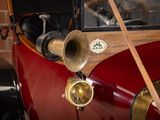 a close up of a red car with a wooden handle