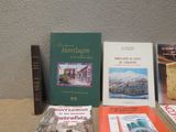 several books are sitting on a table next to each other