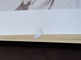 a picture of a bird sitting on top of a book